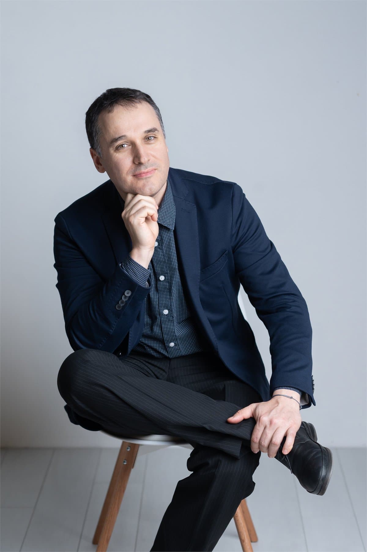 Ivan Yosifov seated in a studio portrait.